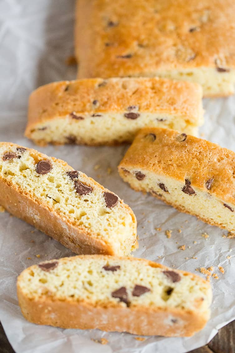 Soft biscotti sliced and laying on parchment paper.