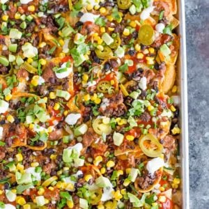 A sheet pan full of loaded nachos.