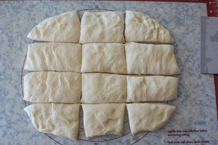 Milk Bread dough rolled out and cut into 12 pieces.