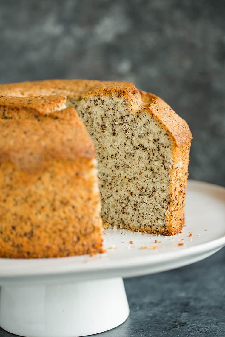 Chocolate Chip Chiffon Cake on a cake platter with a slice removed.
