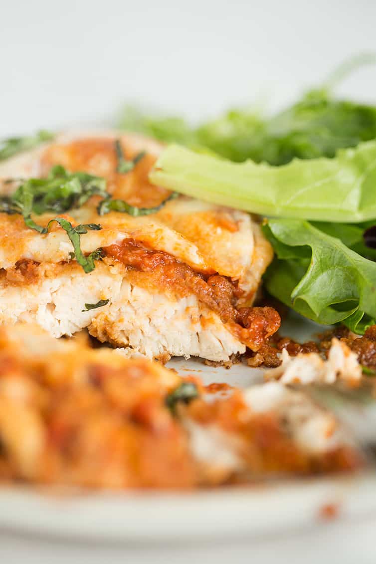 A slice of chicken parmesan sliced.