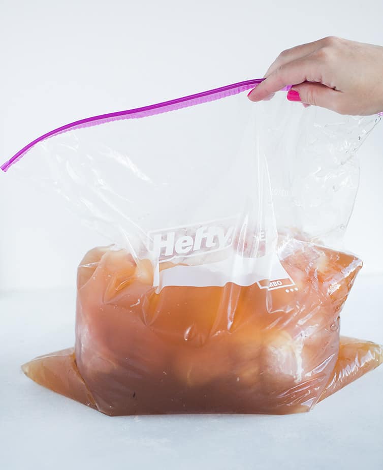 Pork butt in a brine in a large plastic bag.