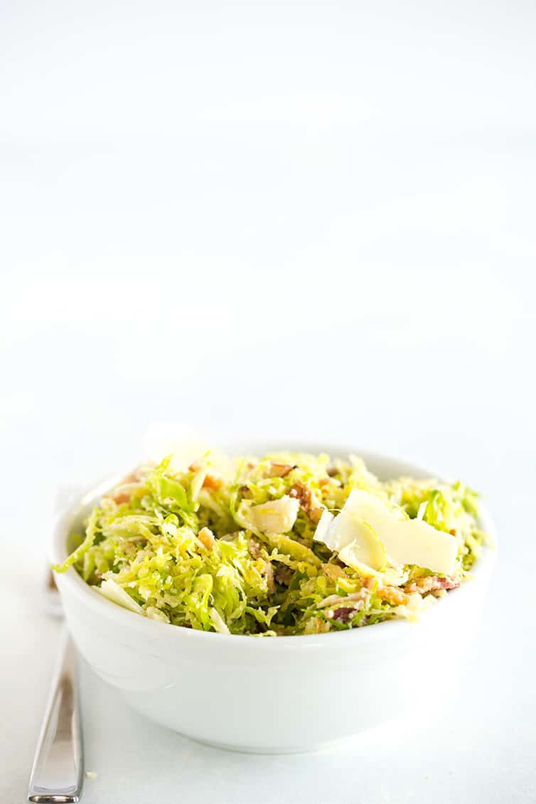 A white bowl with Brussels sprouts salad.