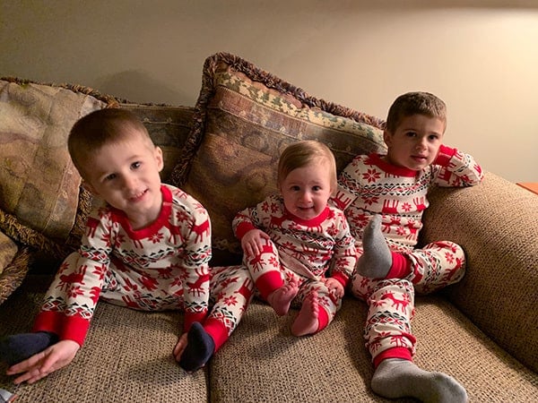 Dominic, Isabelle and Joseph in matching Christmas pajamas.