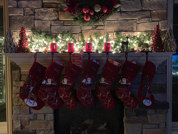 Stocking hanging on the mantle, stuffed with presents.