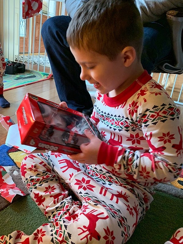 Joseph opening a present.