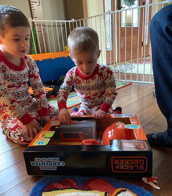 Joseph and Dominic opening a present together.