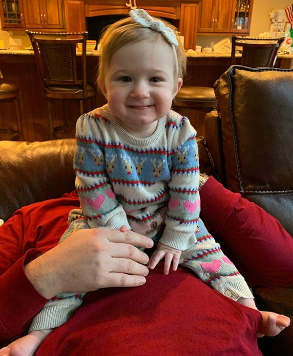 Isabelle sitting up on daddy's tummy.