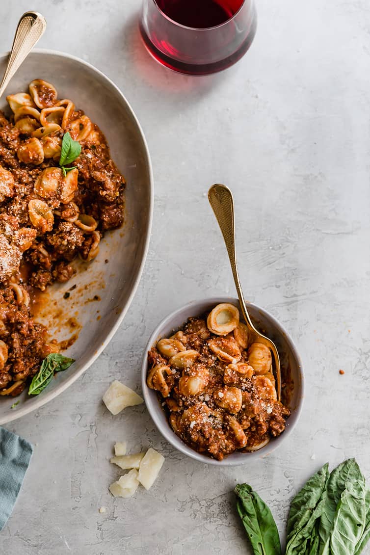 A small dish of pasta with bolognese sauce.
