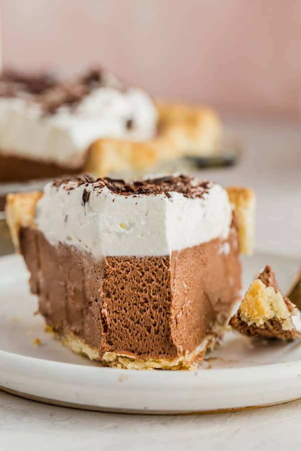 A closeup photo of a slice of French silk pie with a forkful removed.