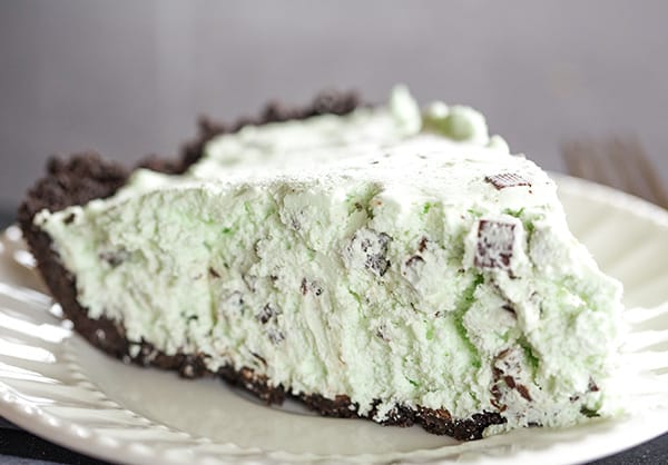 A slice of mint chocolate chip pie on a plate.