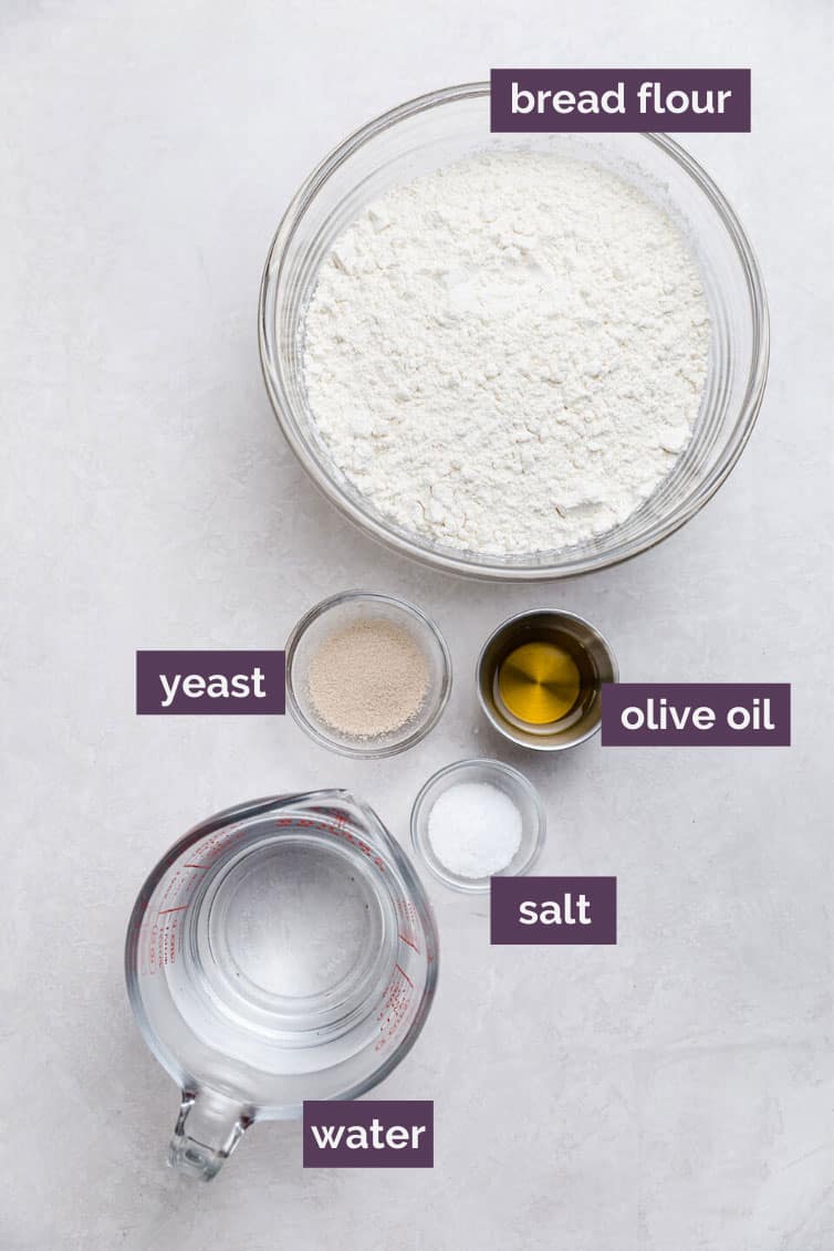 Pizza crust ingredients prepped in bowls on counter.