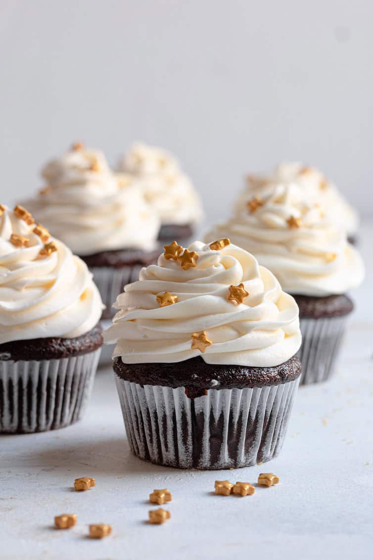Chocolate cupcakes topped with cream cheese frosting.