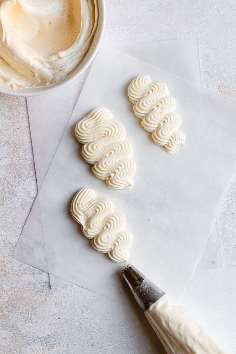 Cream Cheese Frosting piped onto wax paper.