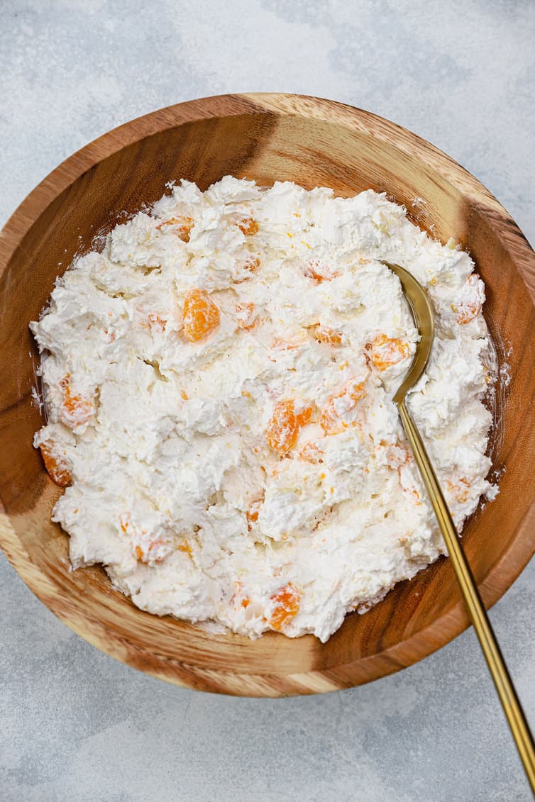 An overhead photo of ambrosia in wooden bowl.