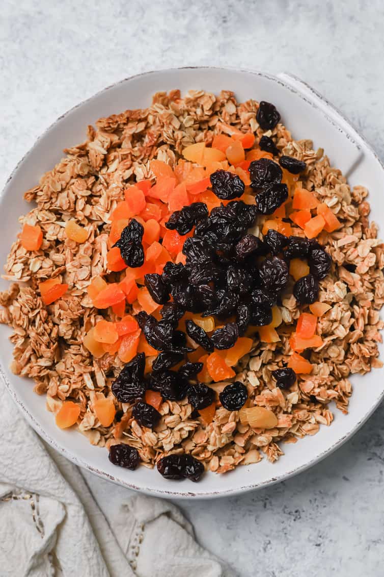 A bowl of granola with dried fruit on top.