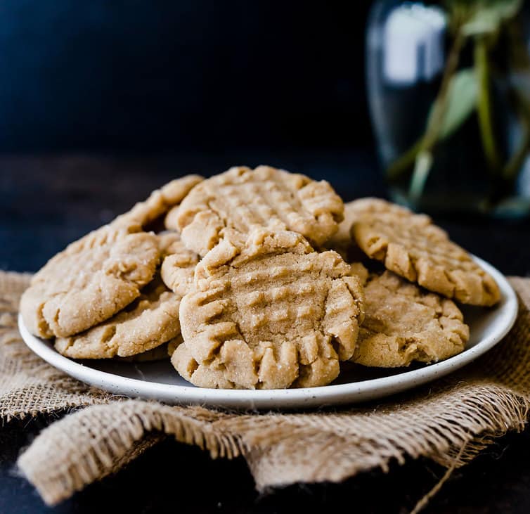 A plate piled high with peanut butter cookies.