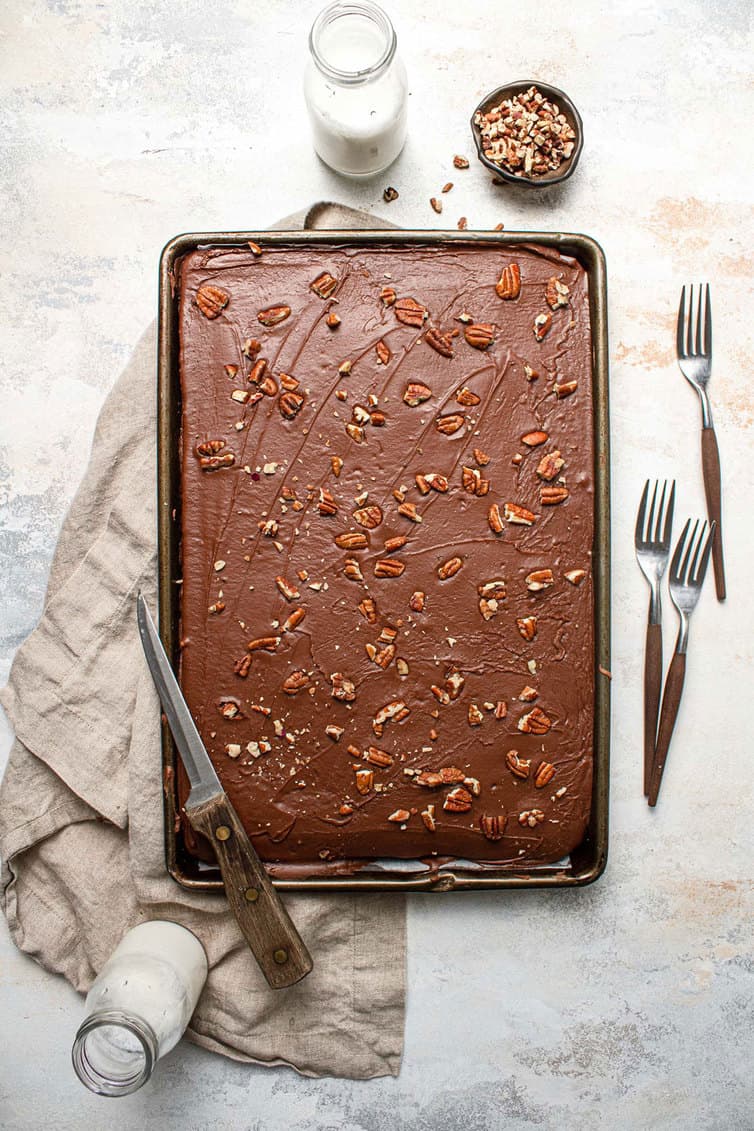 A pan of chocolate Texas sheet cake with pecans.