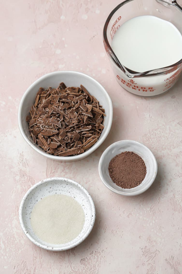 Ingredients for frozen hot chocolate prepped in bowls on counter.