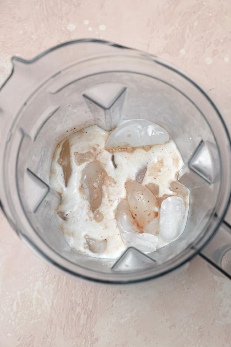 Ice, milk, and chocolate mixture in a blender.