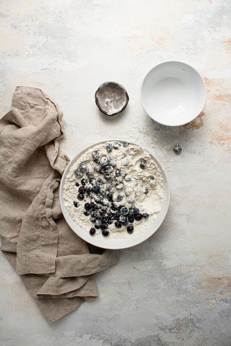 Mixing together blueberry muffin batter.