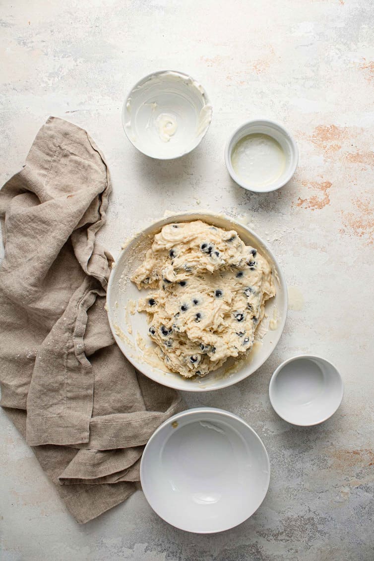 Blueberry muffin batter mixed together in a bowl.