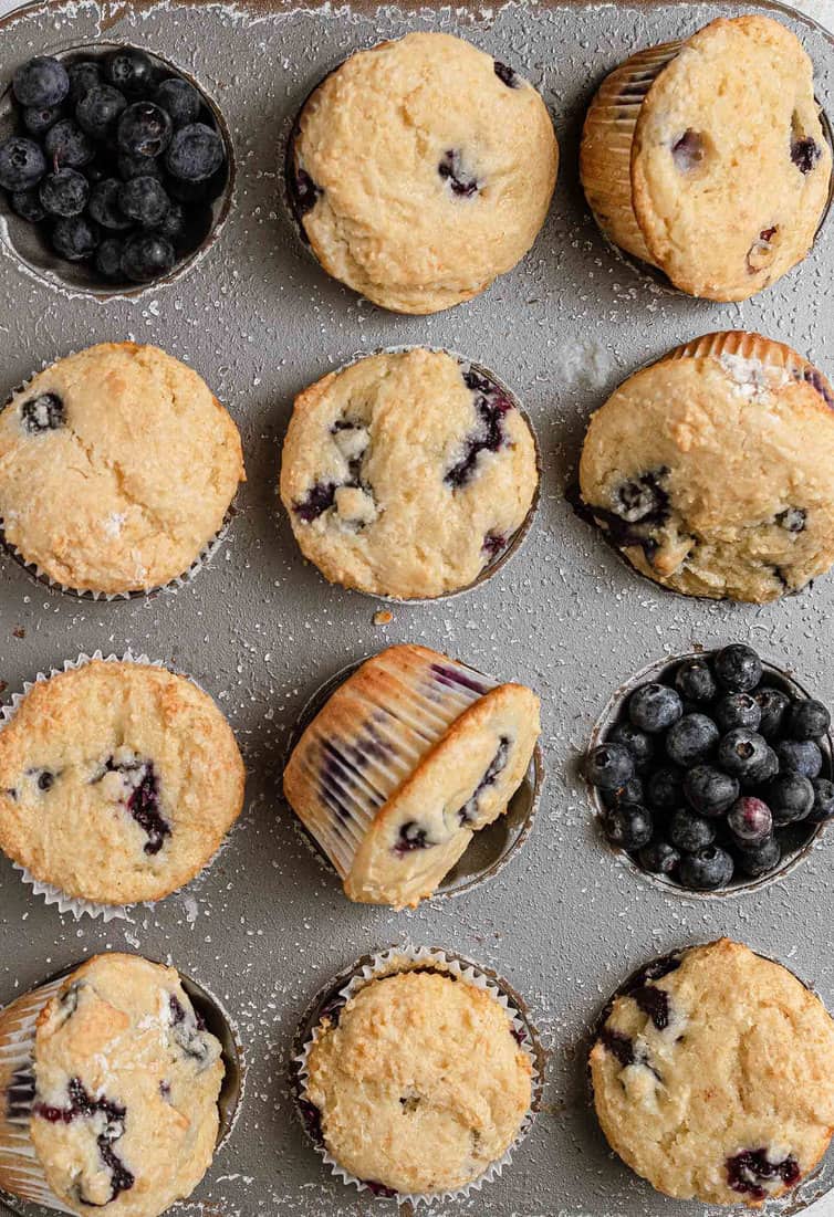 Baked blueberry muffins in a muffin pan.