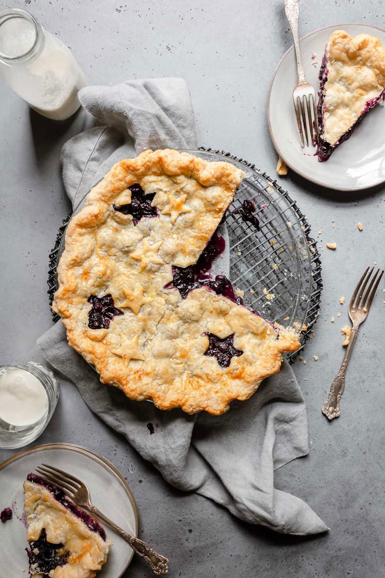 Blueberry pie with two slices removed.