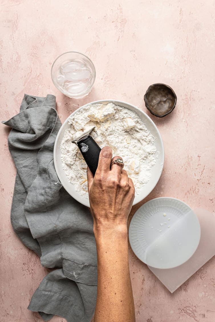 Cutting butter into dry ingredients for pie crust.