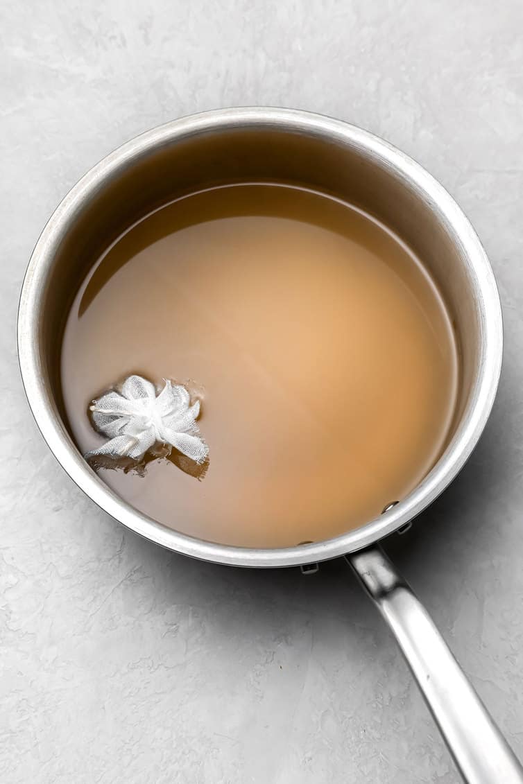 Pickling liquid with spice basket.