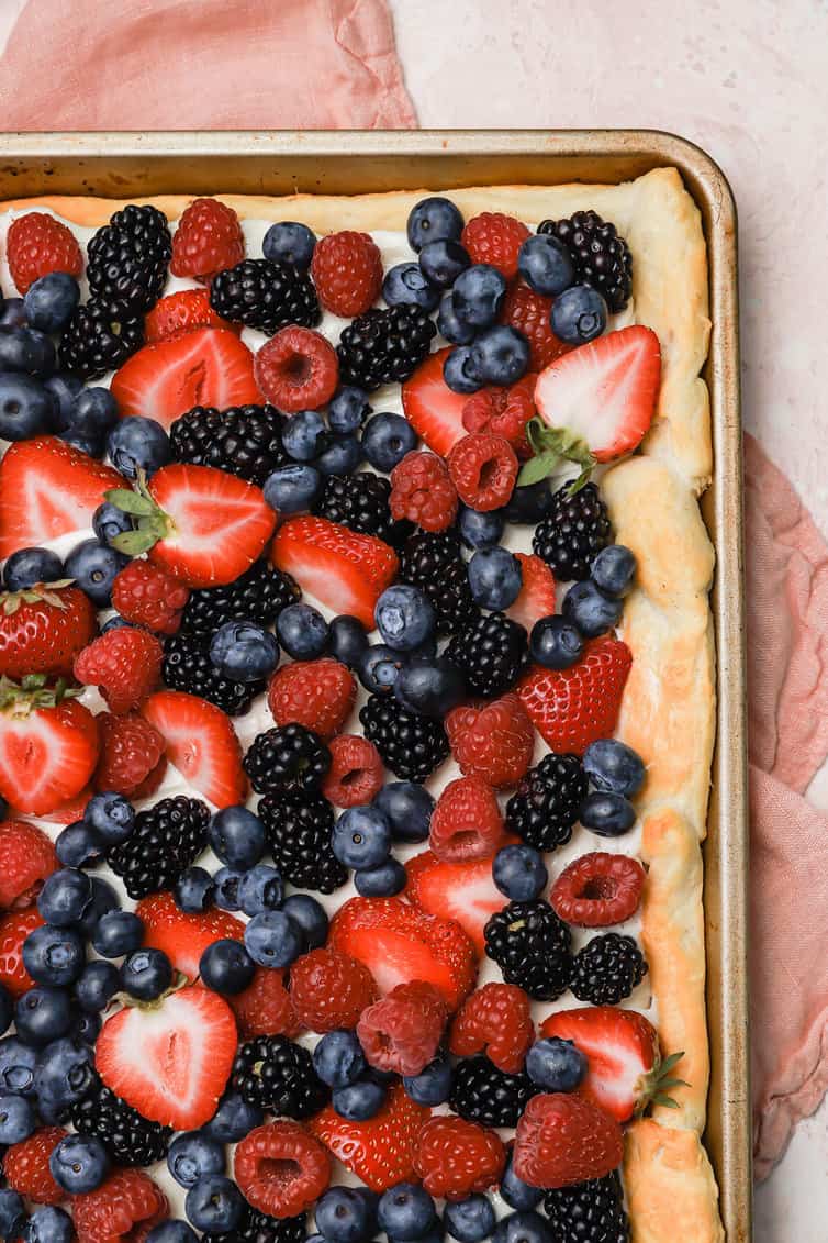 Fruit pizza topped with fresh berries.