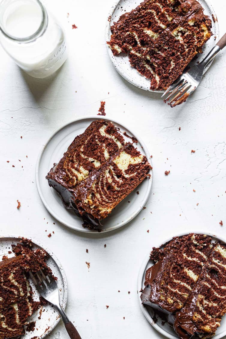 Individual slices of zebra cake on plates.