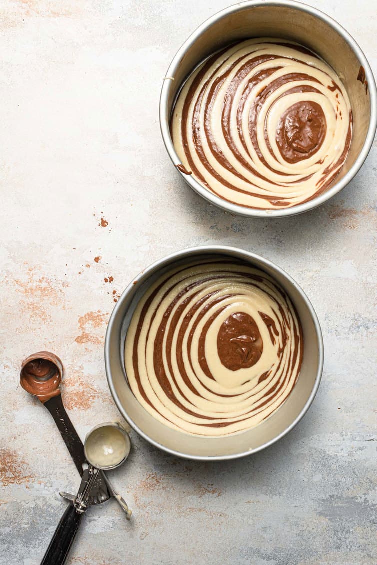 Cake pans filled with zebra cake batter.