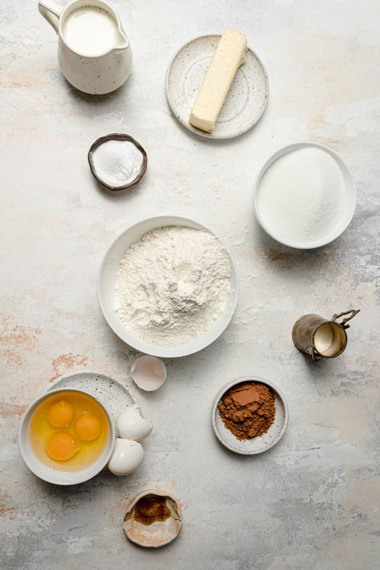 Ingredients for zebra cake prepped in bowls in counter.