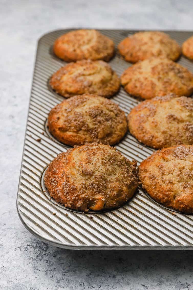 Baked apple muffins still in pan.
