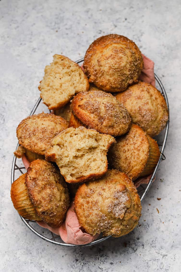 A basket of apple muffins with one split in half.
