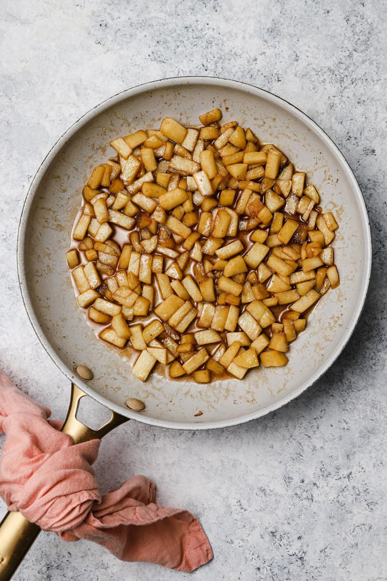Chopped apples cooked in a skillet.