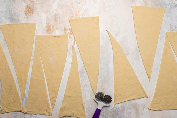 Croissant dough cut into triangles.