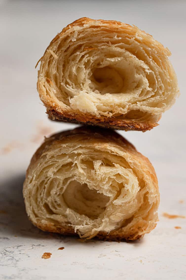 Two halves of a croissant stacked on top of each other.