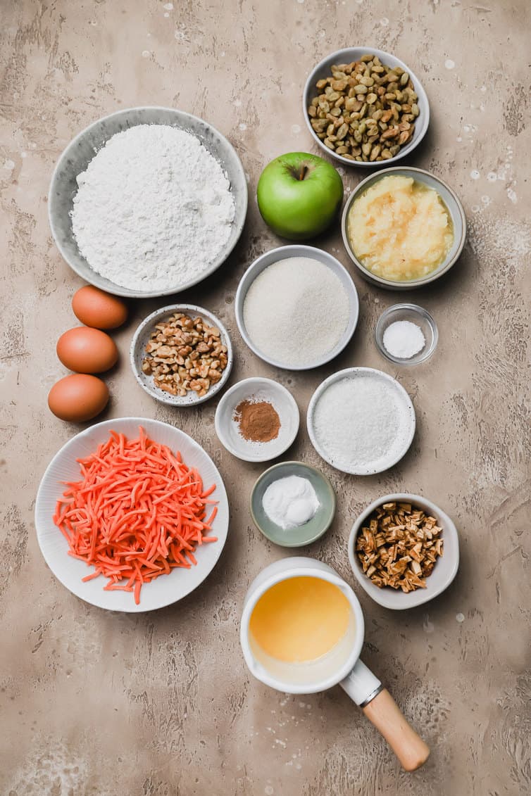 Ingredients for morning glory muffins prepped in bowls on a counter.