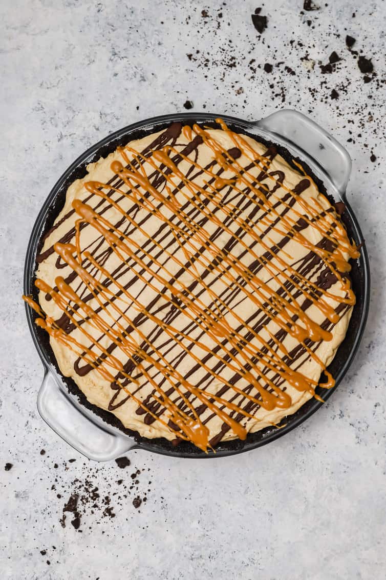 Overhead photo of peanut butter pie drizzled with peanut butter and chocolate.