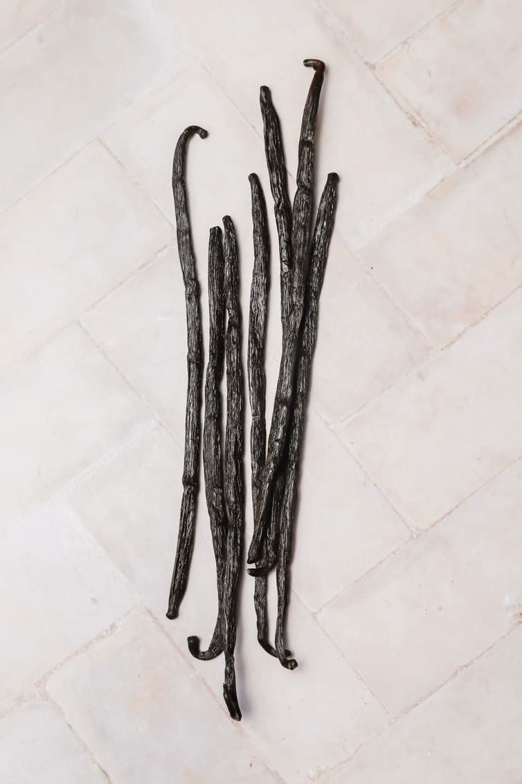 Whole vanilla beans on the counter.