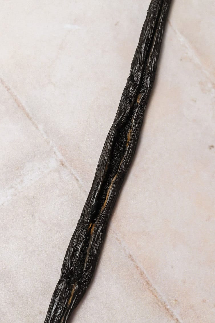 A single vanilla bean split down the center.