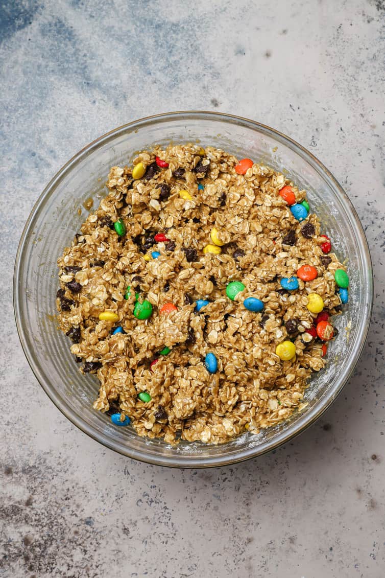 Monster cookie dough mixed together in glass bowl.