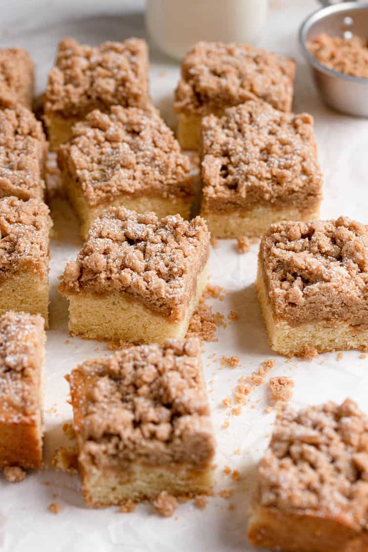 Squares of crumb cake on a cutting surface.