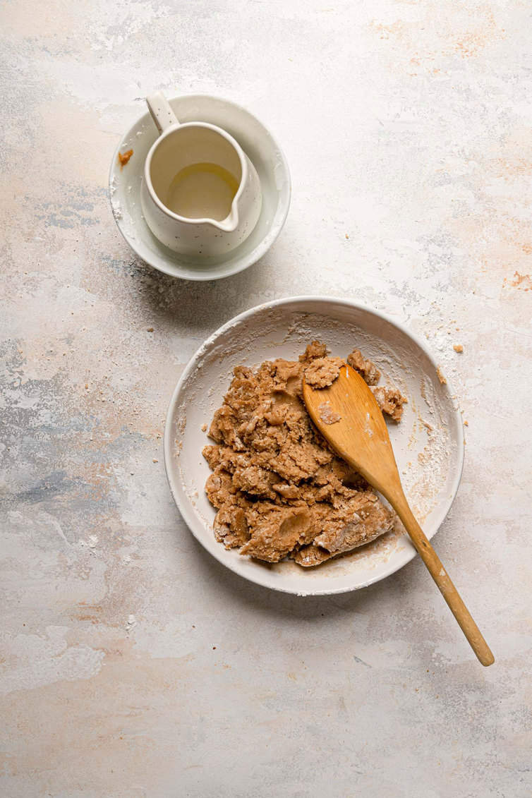 A bowl with the crumb topping mixture for crumb cake.