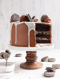 Three layer Oreo cake with a slice taken out.