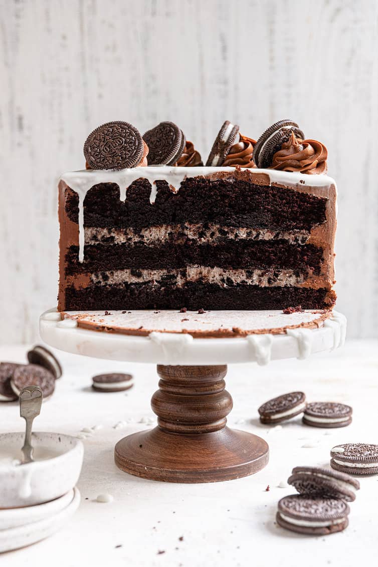 Half of an Oreo cake on a cake pedastal.