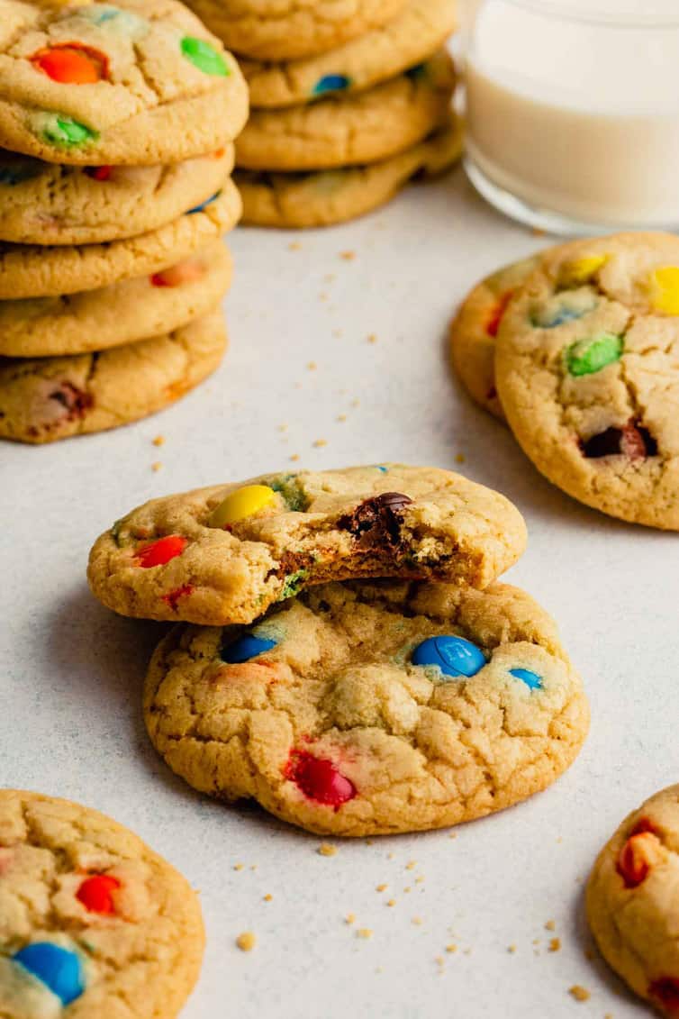 M&M cookies with one having a bite taken out.