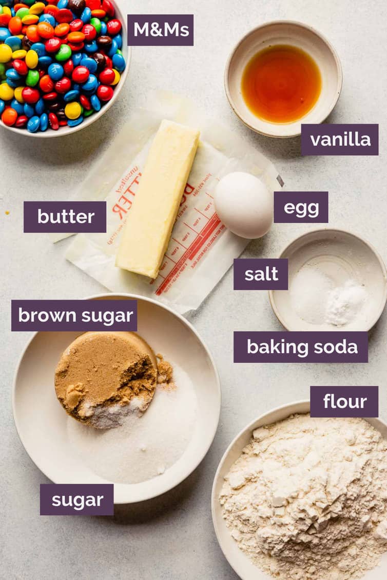 Ingredients for M&M cookies prepped in bowls and labeled.